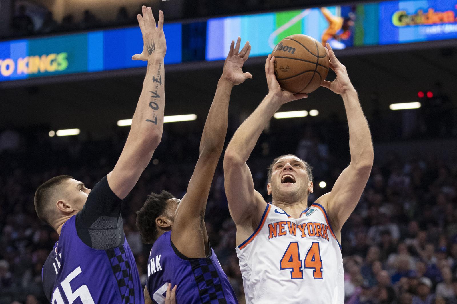 March 16, 2024; Sacramento, California, USA; New York Knicks forward Bojan Bogdanovic (44) shoots the basketball against Sacramento Kings center Alex Len (25) and guard Malik Monk (0) during the second quarter at Golden 1 Center. Mandatory Credit: Kyle Terada-USA TODAY Sports Photo: Kyle Terada/REUTERS