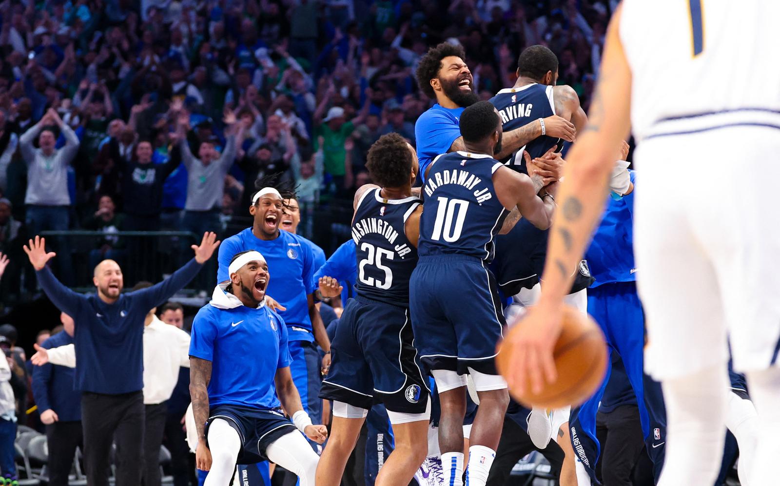 Mar 17, 2024; Dallas, Texas, USA;  Dallas Mavericks guard Kyrie Irving (11) celebrates with teammates after the win against the Denver Nuggets at American Airlines Center. Mandatory Credit: Kevin Jairaj-USA TODAY Sports Photo: Kevin Jairaj/REUTERS