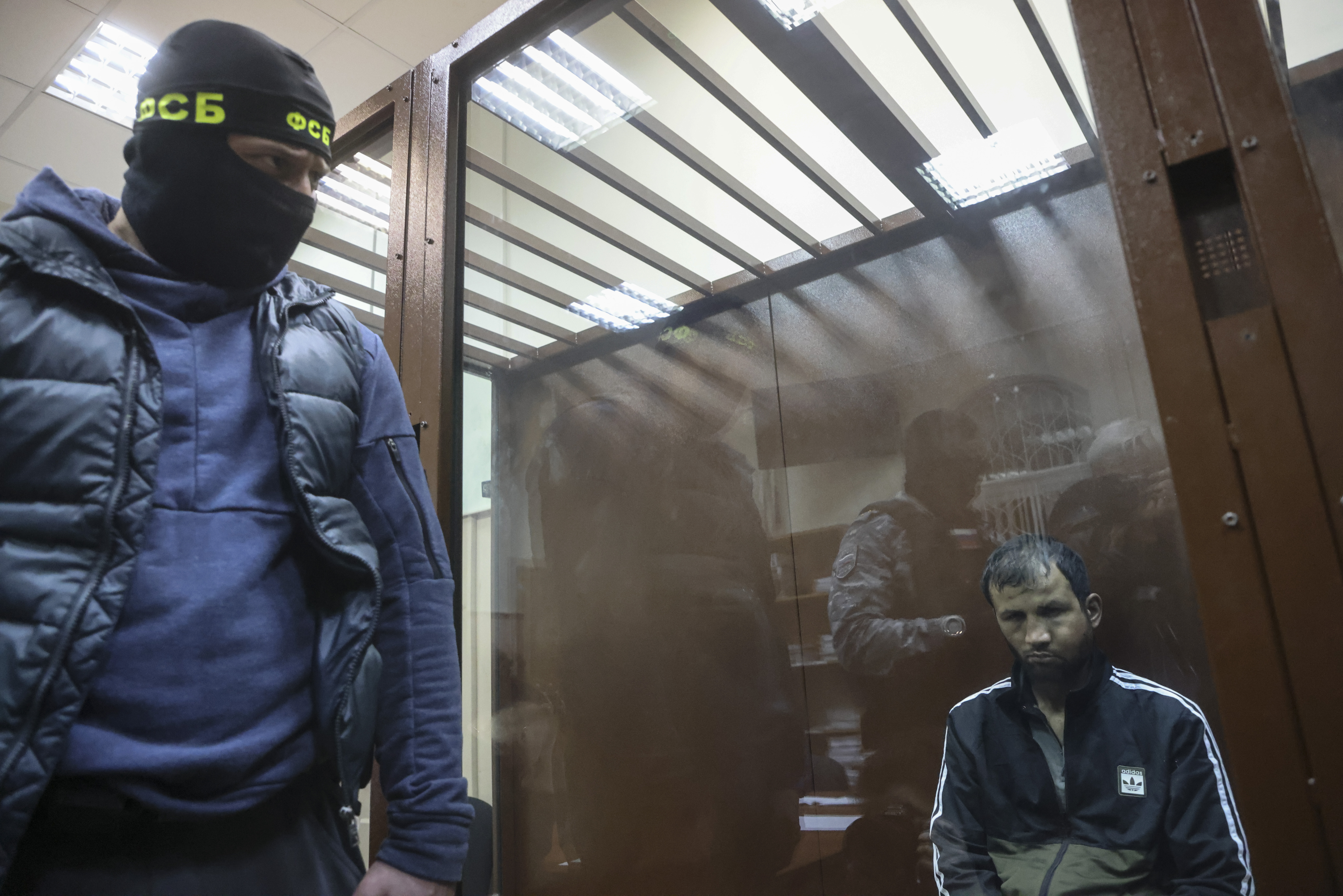 epa11241826 A suspect in the shooting attack on the Crocus City Hall concert venue sits inside a defendant's enclosure during a hearing on pretrial restrictions at Basmanny district court, in Moscow, Russia, 24 March 2024. At least 137 people were killed and more than 180 hospitalized after a group of gunmen attacked the concert hall in the Moscow region on 22 March evening, Russian officials said. Eleven suspects, including all four gunmen directly involved in the terrorist attack, have been detained, according to Russian authorities.  EPA/SERGEI ILNITSKY