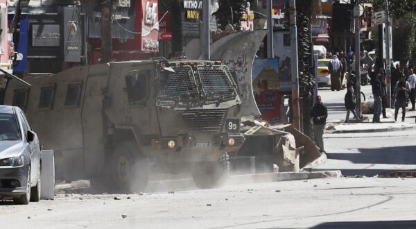 epa11216204 Israeli troops patrol a street at the Jenin refugee camp during a raid by the Israeli forces, near the West Bank city of Jenin, 12 March 2024. According to the Palestinian Health ministry, four Palestinians were wounded in the raid.  EPA/ALAA BADARNEH