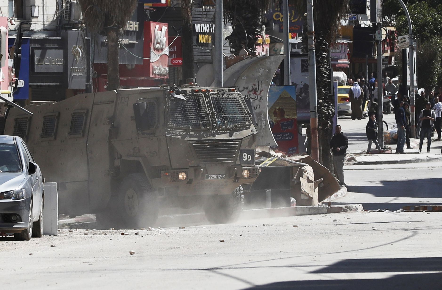 epa11216204 Israeli troops patrol a street at the Jenin refugee camp during a raid by the Israeli forces, near the West Bank city of Jenin, 12 March 2024. According to the Palestinian Health ministry, four Palestinians were wounded in the raid.  EPA/ALAA BADARNEH