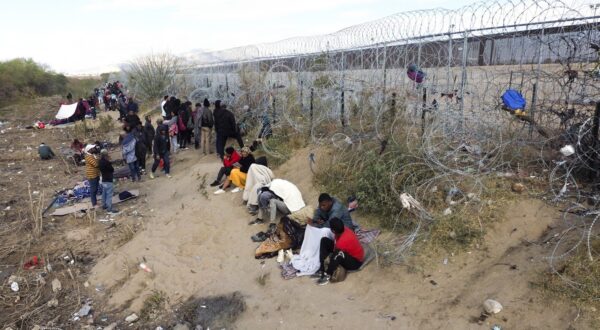 CIUDAD JUAREZ , MEXICO - MARCH 19: Some lying down, others standing, among garbage and wire with razor blades, migrants try to persuade the agents of the Texas National Guard to open the fence, which is guarded, installed days ago with the intention of complicating the crossing of migrants who reach this border in Ciudad Juarez, Mexico on March 19, 2024. The blockade is permanent by the military, so migrants choose to set up a camp on the side of Rio Bravo, a bonfire makes them gather near it, four blankets serve as shelter against the few rays of the sun on the cloudy morning of Tuesday to a family. Christian Torres / Anadolu,Image: 858095375, License: Rights-managed, Restrictions: , Model Release: no, Credit line: AA/ABACA / Abaca Press / Profimedia