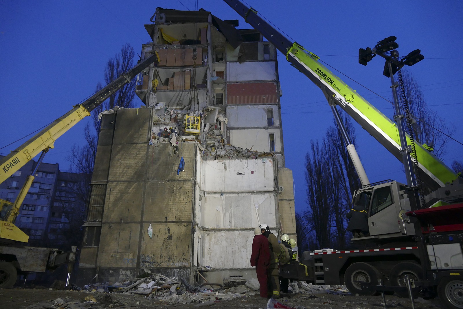 epa11197128 Ukrainian rescuers continue to clean debris on the site of a damaged residential building after a Russian drone attack one day eralier, in the southern city of Odesa, Ukraine, 03 March 2024.  By 03 March, twelve people are known to have died, including three children and eight others were injured, following the  drone attack of 02 March, according to the Ukraine's State Emergency Service report. Russian troops entered Ukraine in February 2022 starting a conflict that has provoked destruction and a humanitarian crisis.  EPA/IGOR TKACHENKO