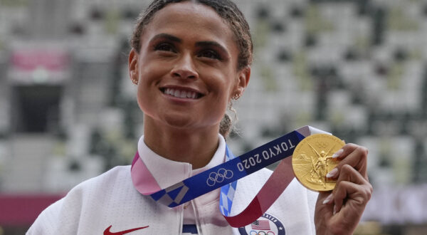 FILE - Gold medalist Sydney McLaughlin, of the United States, poses during the medal ceremony for the women's 400-meter hurdles at the 2020 Summer Olympics, Wednesday, Aug. 4, 2021, in Tokyo. (AP Photo/Francisco Seco, File)