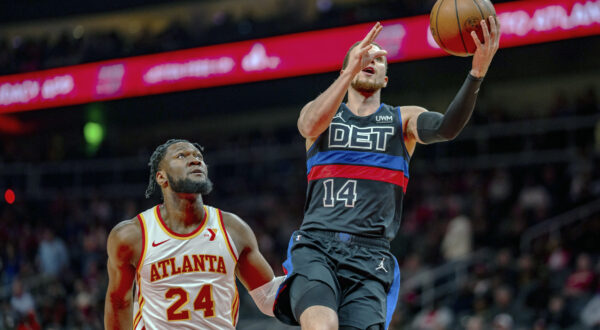 Detroit Pistons point guard Malachi Flynn (14) goes up for a layup against Atlanta Hawks forward Bruno Fernando (24) during the first half of an NBA basketball game, Wednesday, April 3, 2024, in Atlanta. (AP Photo/Jason Allen)