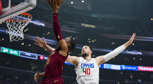 Cleveland Cavaliers forward Isaac Okoro, left, drives past Los Angeles Clippers center Ivica Zubac during the first half of an NBA basketball game, Sunday, April 7, 2024, in Los Angeles. (AP Photo/Ryan Sun)