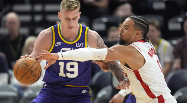 Houston Rockets forward Dillon Brooks, right, guards Utah Jazz forward Luka Samanic (19) during the second half of an NBA basketball game Thursday, April 11, 2024, in Salt Lake City. (AP Photo/Rick Bowmer)