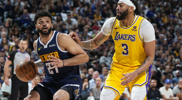 Denver Nuggets guard Jamal Murray, left, drives to the basket as Los Angeles Lakers forward Anthony Davis, right, defends in the first half of Game 5 of an NBA basketball first-round playoff series Monday, April 29, 2024, in Denver. (AP Photo/David Zalubowski)