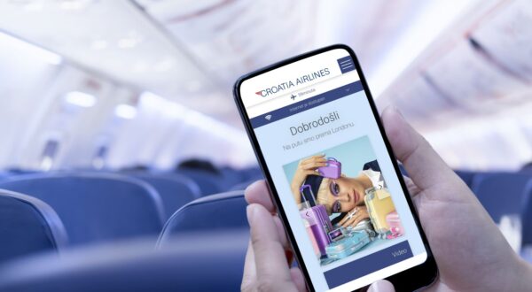 Airplane passenger using smart phone on plane. Businessman touching blank screen mobile phone at airplane. for graphics display montage.