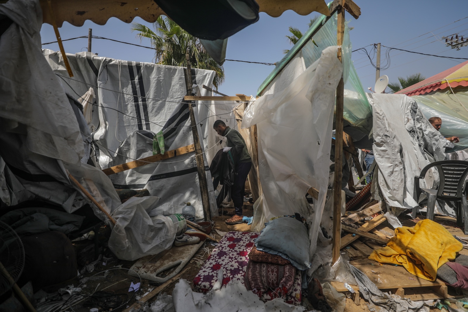 epa11252942 Palestinians inspect destroyed shelter tents following an Israeli air strike near Al Aqsa hospital, in Deir Al Balah town in southern Gaza Strip, 31 March 2024. Three Palestinian journalists were wounded and two displaced persons were killed in the air strike, according to Palestinian Civilian Defence. More than 32,700 Palestinians and over 1,450 Israelis have been killed, according to the Palestinian Health Ministry and the Israel Defense Forces (IDF), since Hamas militants launched an attack against Israel from the Gaza Strip on 07 October 2023, and the Israeli operations in Gaza and the West Bank which followed it.  EPA/MOHAMMED SABER