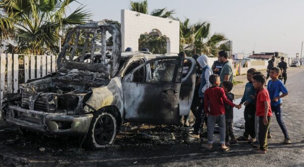 epa11255094 People stand near a destroyed car of the NGO World Central Kitchen (WCK) along Al Rashid road, between Deir Al Balah and Khan Younis in the southern Gaza Strip, 02 April 2024. According to the Palestinian Red Crescent, at least four people from the NGO World Central Kitchen (WCK) were killed when a missile hit their convoy in Deir al Balah while they were on their way from Rafah to Gaza City to receive fresh aid delivered by the Open Arms vessel. The victims were confirmed to be a British, a Polish and an Australian citizen, while the nationality of the fourth victim was still unknown.  EPA/MOHAMMED SABER  EPA-EFE/MOHAMMED SABER
