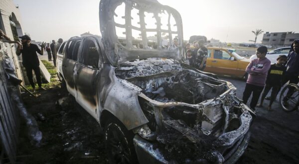 epa11255142 People stand near a destroyed car of the NGO World Central Kitchen (WCK) along Al Rashid road, between Deir Al Balah and Khan Younis in the southern Gaza Strip, 02 April 2024. According to the Palestinian Red Crescent, at least four people from the NGO World Central Kitchen (WCK) were killed when a missile hit their convoy in Deir al Balah while they were on their way from Rafah to Gaza City to receive fresh aid delivered by the Open Arms vessel. The victims were confirmed to be a British, a Polish and an Australian citizen, while the nationality of the fourth victim was still unknown.  EPA/MOHAMMED SABER