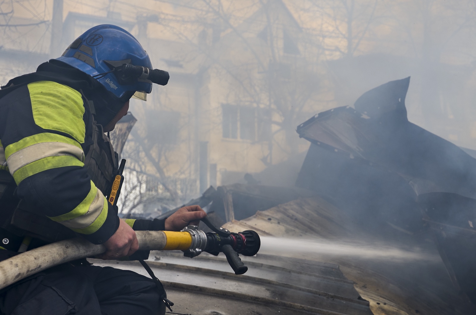 epa11264341 Ukrainian rescue services work at the site of a rocket attack on a residential area in Kharkiv, northeastern Ukraine, 07 April 2024, amid the Russian invasion. At least four people were wounded in the rocket attack, according to a report by the State Emergency Service. Russian troops entered Ukrainian territory on 24 February 2022, starting a conflict that has provoked destruction and a humanitarian crisis.  EPA/SERGEY KOZLOV 48947