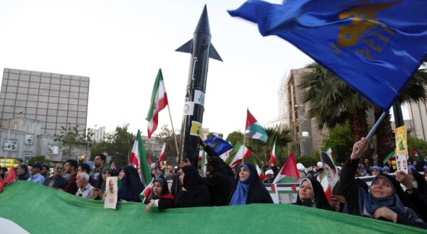epa11280624 Iranians hold a mock missile during a celebration following Iran's attack on Israel, at the Palestine square, in Teheran, Iran, 15 April 2024. Iran's Islamic Revolutionary Guards Corps (IRGC) launched drones and rockets towards Israel late on 13 April 2024, Iranian officials said.  EPA/ABEDIN TAHERKENAREH
