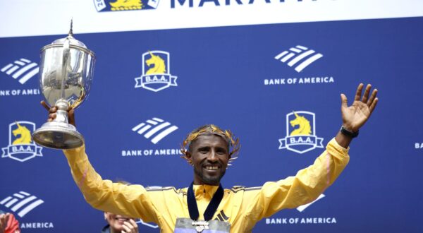epa11280668 Sisay Lemma of Ethiopia celebrates with his trophy on the podium after winning the Men’s division of the 128th Boston Marathon in Boston, Massachusetts, USA, 15 April 2024.  EPA/CJ GUNTHER