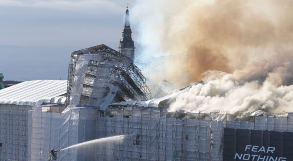 epa11281365 Firefighters work to extinguish a fire at the old Stock Exchange (Boersen) in Copenhagen, Denmark, 16 April 2024. A violent fire broke out in the building which is under renovation on the morning of 16 April. The building was erected in the 1620s as a commercial building by King Christian IV and is located next to the Danish parliament.  EPA/Emil Helms DENMARK OUT