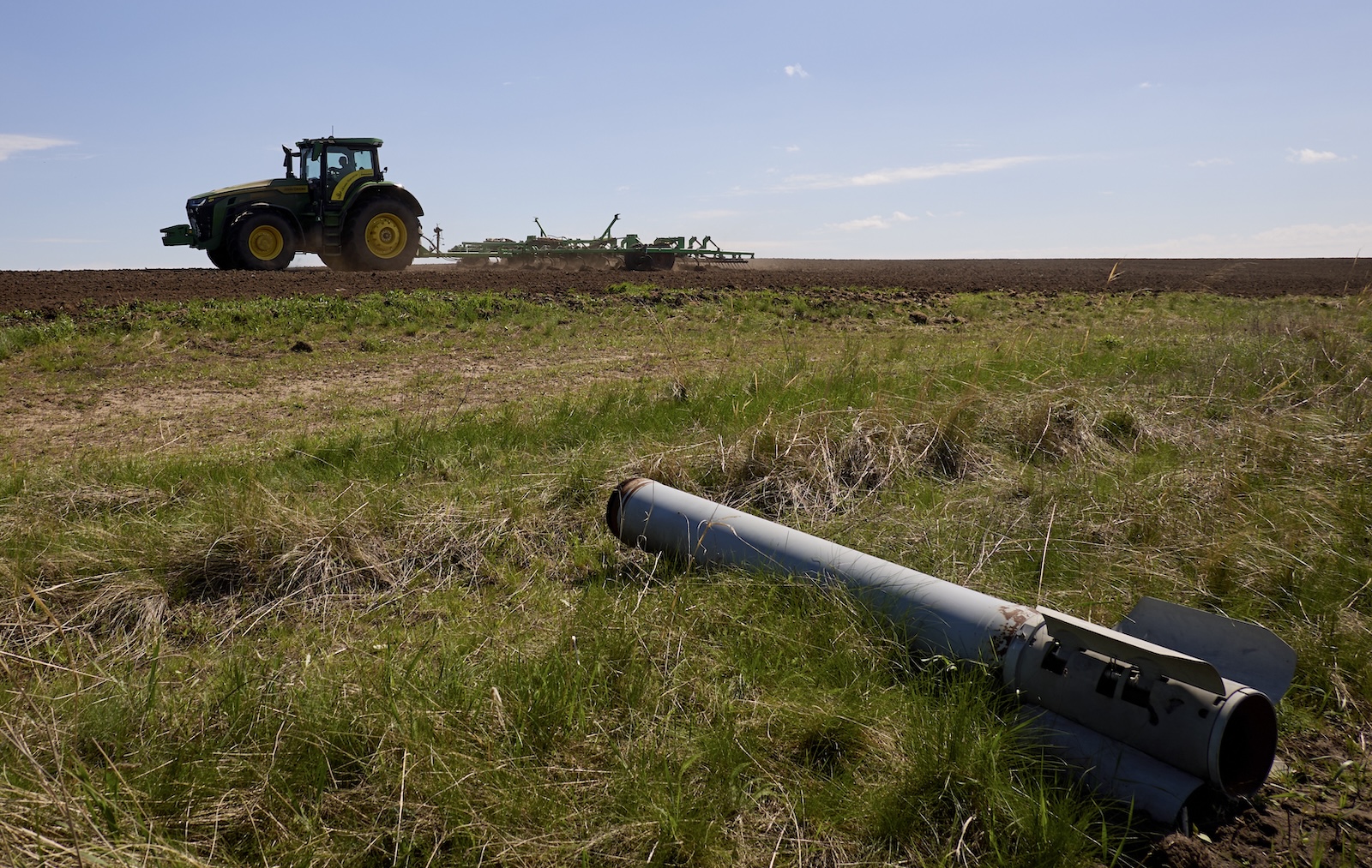 epaselect epa11290627 A tractor works in a field near Vysokopolie village, Kharkiv region, northeastern Ukraine, 20 April 2024, amid the ongoing Russian invasion. Ukrainian farmers , with the help of workers trained to use metal detectors, have their fields checked before agricultural machinery can do any work. If ammunition remnants are found, they ask sappers to assess whether they pose a threat. Once the danger is over, farmers are able to plant crops in the fields. Russian troops entered Ukraine in February 2022 starting a conflict that has provoked destruction and a humanitarian crisis.  EPA/SERGEY KOZLOV