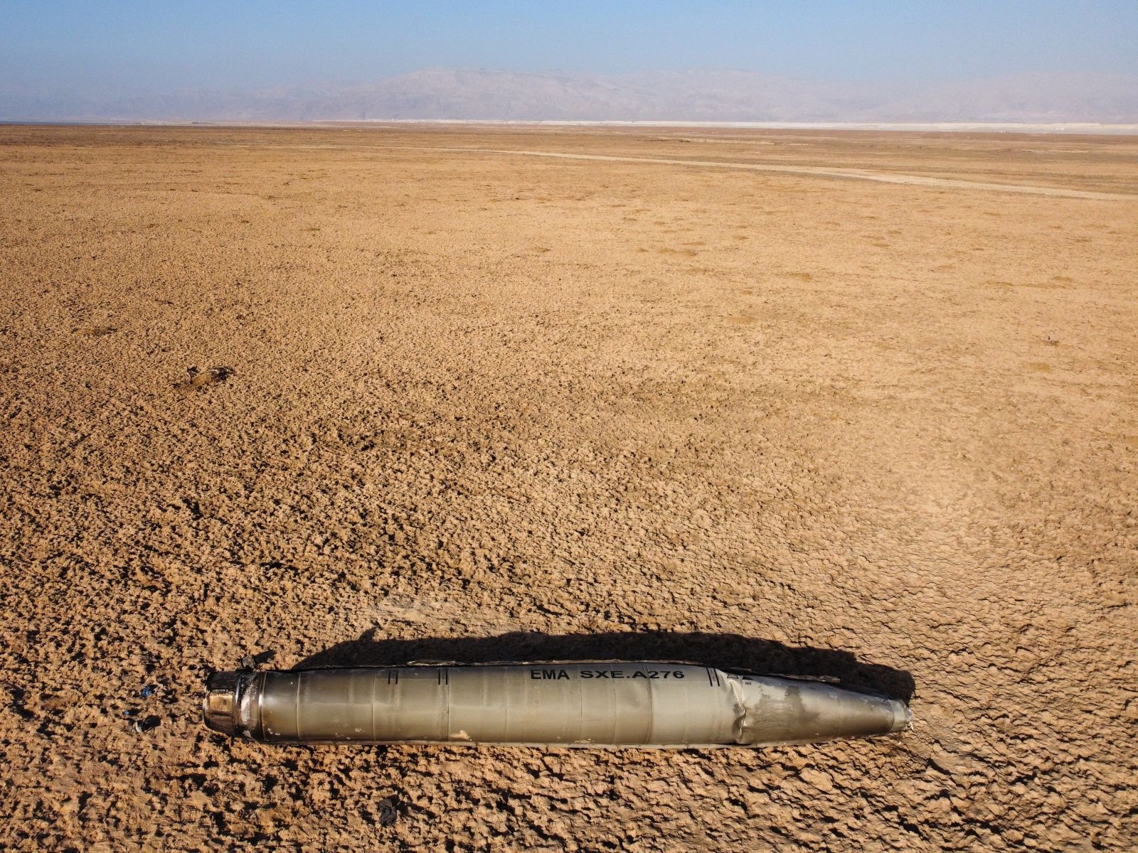 epa11292114 An aerial view taken with a drone shows part of a ballistic missile that fell near the Dead Sea, in eastern Israel, 21 April 2024. The Israeli military said that Israel's defense systems and the country's allies in the region, including the United States, intercepted 99 percent of more than 300 missiles and drones launched from Iran against Israel last weekend. Iran launched an attack against Israel late on 13 April after blaming Israel for an airstrike on its consulate building in Syria's capital Damascus on 01 April, in which seven Islamic Revolutionary Guard Corps (IRGC) members were killed.  EPA/ABIR SULTAN