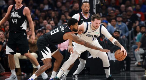Apr 23, 2024; Los Angeles, California, USA; Dallas Mavericks guard Luka Doncic (77) is defended by Los Angeles Clippers forward Paul George (13) during the first quarter of game two of the first round for the 2024 NBA playoffs at Crypto.com Arena. Mandatory Credit: Kiyoshi Mio-USA TODAY Sports Photo: Kiyoshi Mio/REUTERS