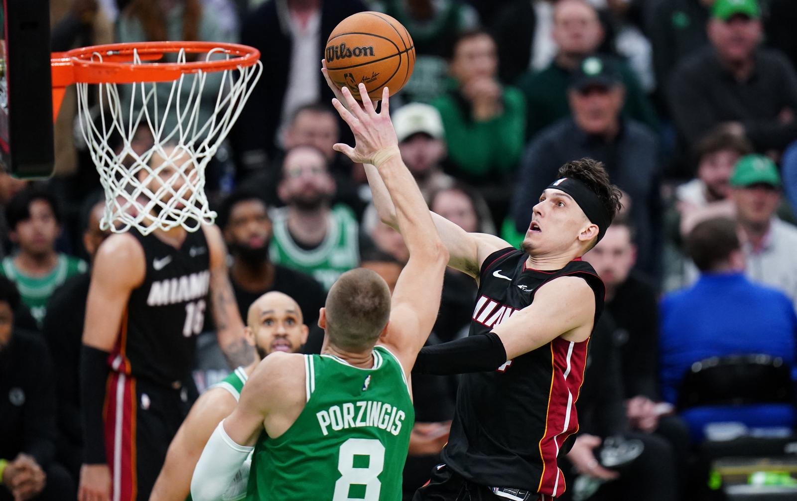Apr 24, 2024; Boston, Massachusetts, USA; Miami Heat guard Tyler Herro (14) drives to the basket against Boston Celtics center Kristaps Porzingis (8) in the second half during game two of the first round for the 2024 NBA playoffs at TD Garden. Mandatory Credit: David Butler II-USA TODAY Sports Photo: David Butler II/REUTERS