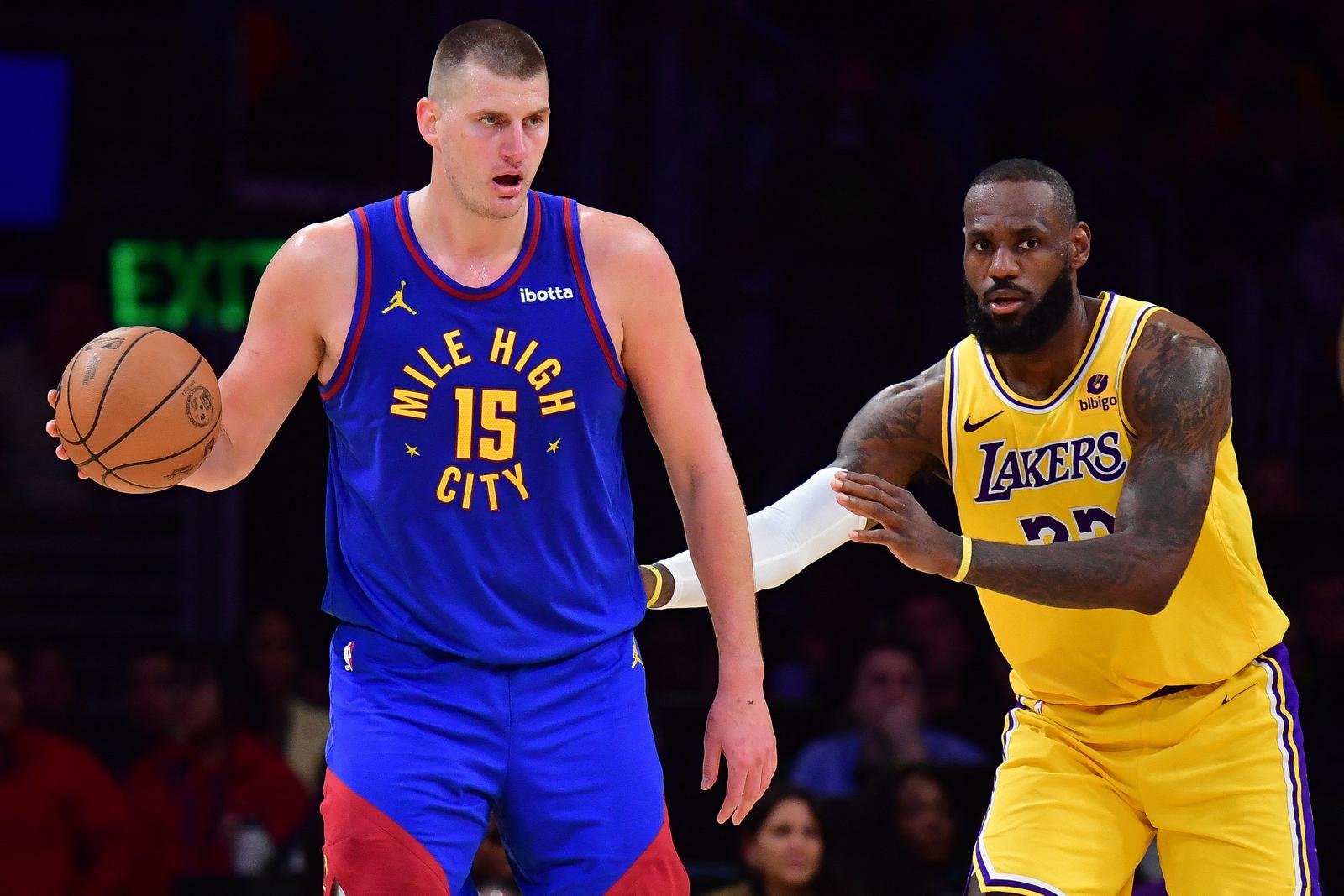 Apr 25, 2024; Los Angeles, California, USA; Denver Nuggets center Nikola Jokic (15) controls the ball against Los Angeles Lakers forward LeBron James (23)  during the second half in game three of the first round for the 2024 NBA playoffs at Crypto.com Arena. Mandatory Credit: Gary A. Vasquez-USA TODAY Sports Photo: Gary A. Vasquez/REUTERS