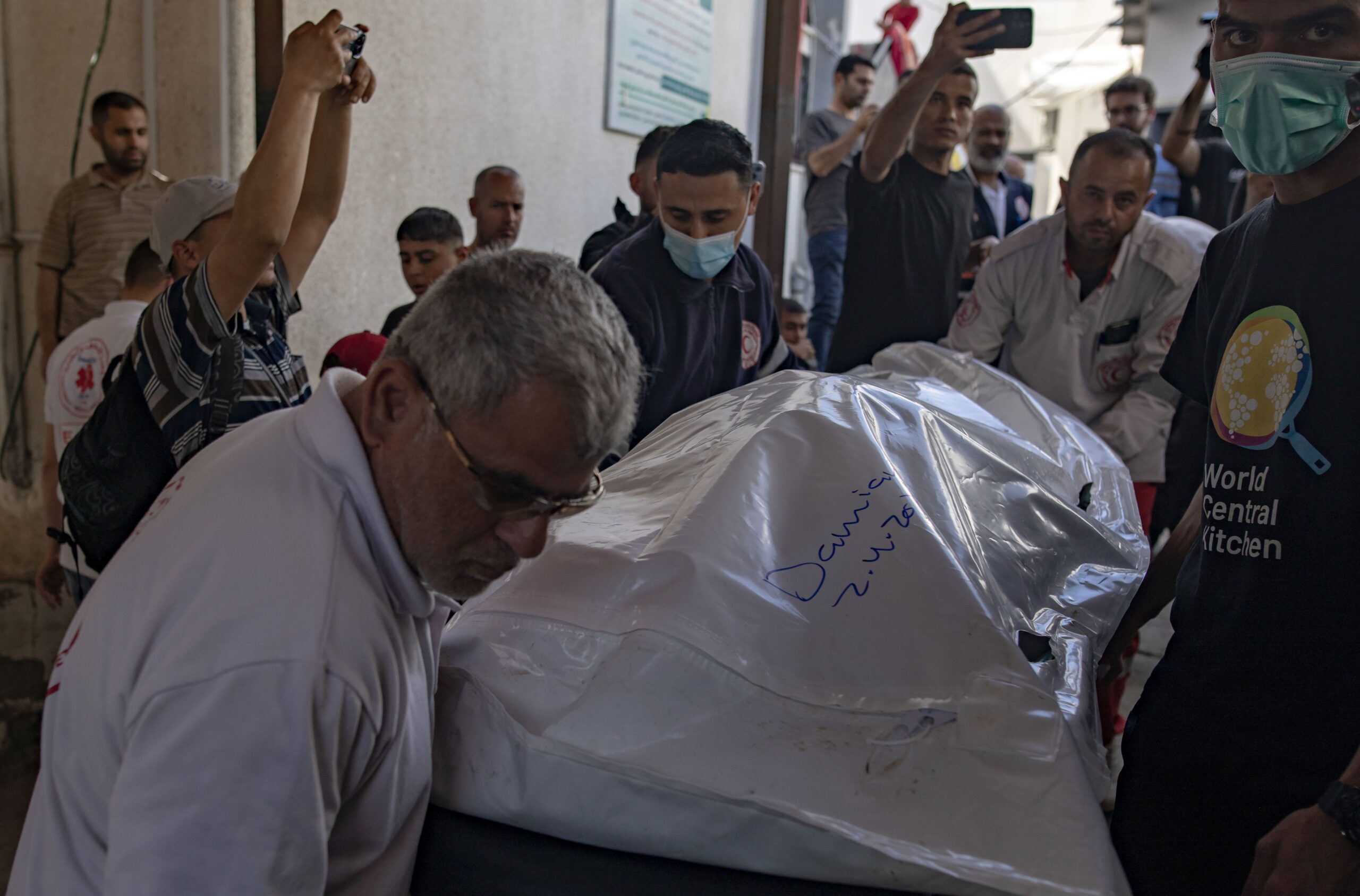 epa11256881 World Central Kitchen workers move the bodies of their colleagues from Al-Najjar Hospital to the Rafah crossing for expatriation, 03 April 2024. The bodies of six foreign aid workers killed in a Gaza strike are to be transported out via Egypt.  EPA/HAITHAM IMAD