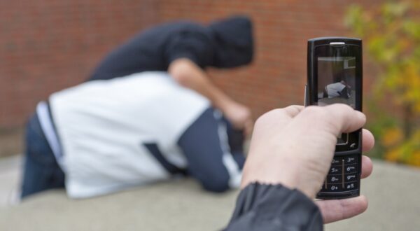 Boy pushing another boy down onto a table tennis table being filmed with a mobile phone,Image: 88644897, License: Rights-managed, Restrictions: , Model Release: yes, Credit line: Siegfried Kuttig / imageBROKER / Profimedia