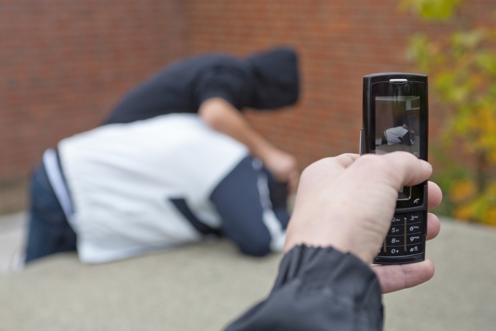 Boy pushing another boy down onto a table tennis table being filmed with a mobile phone,Image: 88644897, License: Rights-managed, Restrictions: , Model Release: yes, Credit line: Siegfried Kuttig / imageBROKER / Profimedia