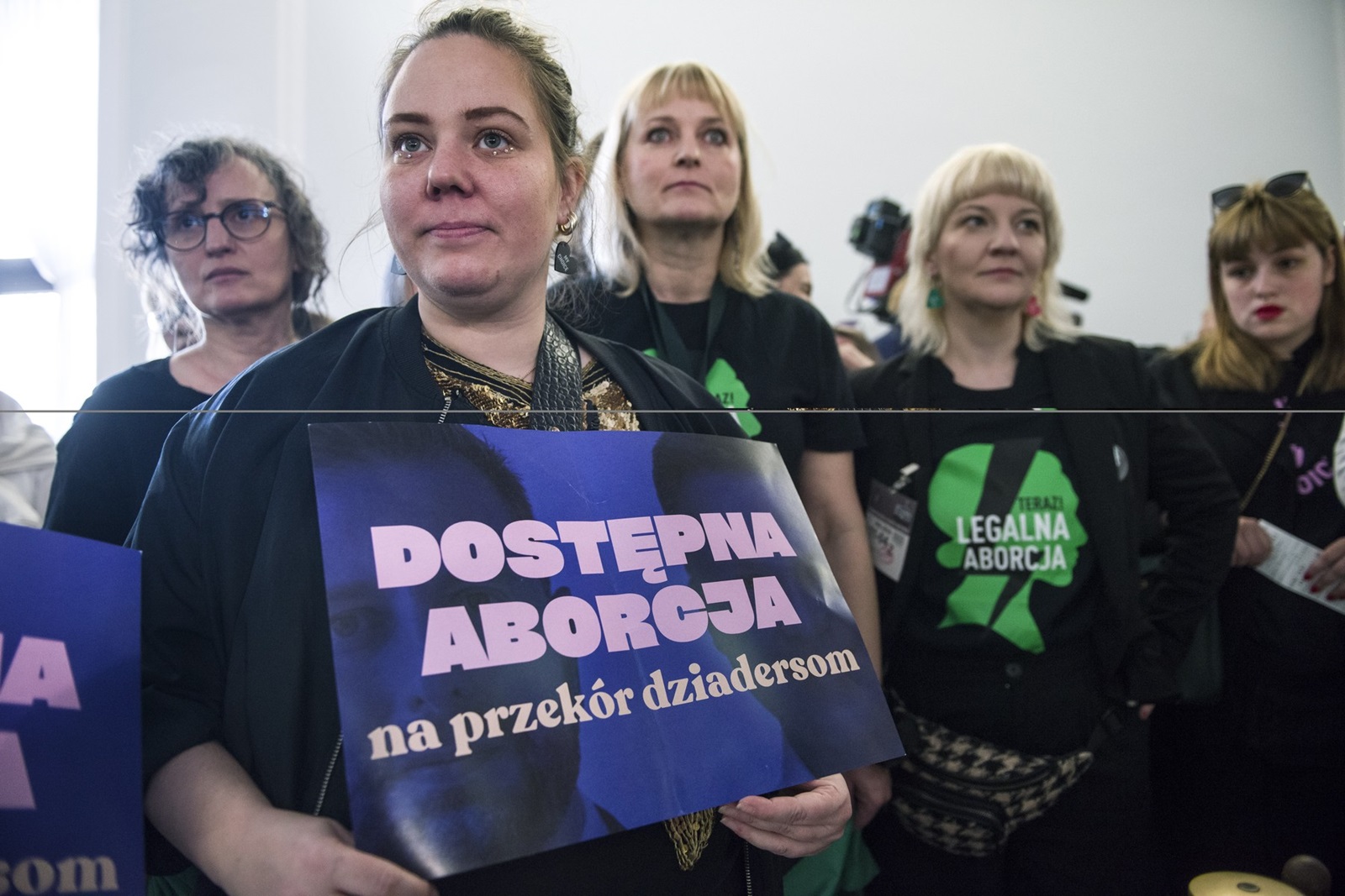April 11, 2024, Warsaw, Poland: An activist of the Women's Strike (Strajk Kobiet) organisation holds a placard that reads Access to abortion at a press conference in the Parliamentary hall. Poland's parliament holds a long-awaited debate on liberalization of the country's strict abortion law. The traditionally Catholic nation has one of the most restrictive laws in Europe but the reality is that many women terminate pregnancies at home with pills mailed from abroad. Lawmakers in the lower house (Sejm) of parliament will consider four different proposals on 11th and 12th April during the 9th session of the Parliament. Currently abortion is regulated by a 1993 law, which was heavily influenced by the Catholic church, and further restricted following a 2020 constitutional court ruling preventing abortion in case of fetal abnormalities. Marta Lempart, the leader of the Women's Strike organization (Strajk Kobiet), also appeared in the Sejm, along with pro-abortion activists who were not allowed into the session room. During the debate on the liberalization of abortion in the Sejm, outside the parliament, Kaja Godek - the ultra-right-wing and Catholic leader of the pro-life Ordo Iuris association - protested against the liberalization of abortion bill and, together with pro-life activists, put up obscene banners with fetal bodies in the street.,Image: 864097944, License: Rights-managed, Restrictions: , Model Release: no, Credit line: Attila Husejnow / Zuma Press / Profimedia