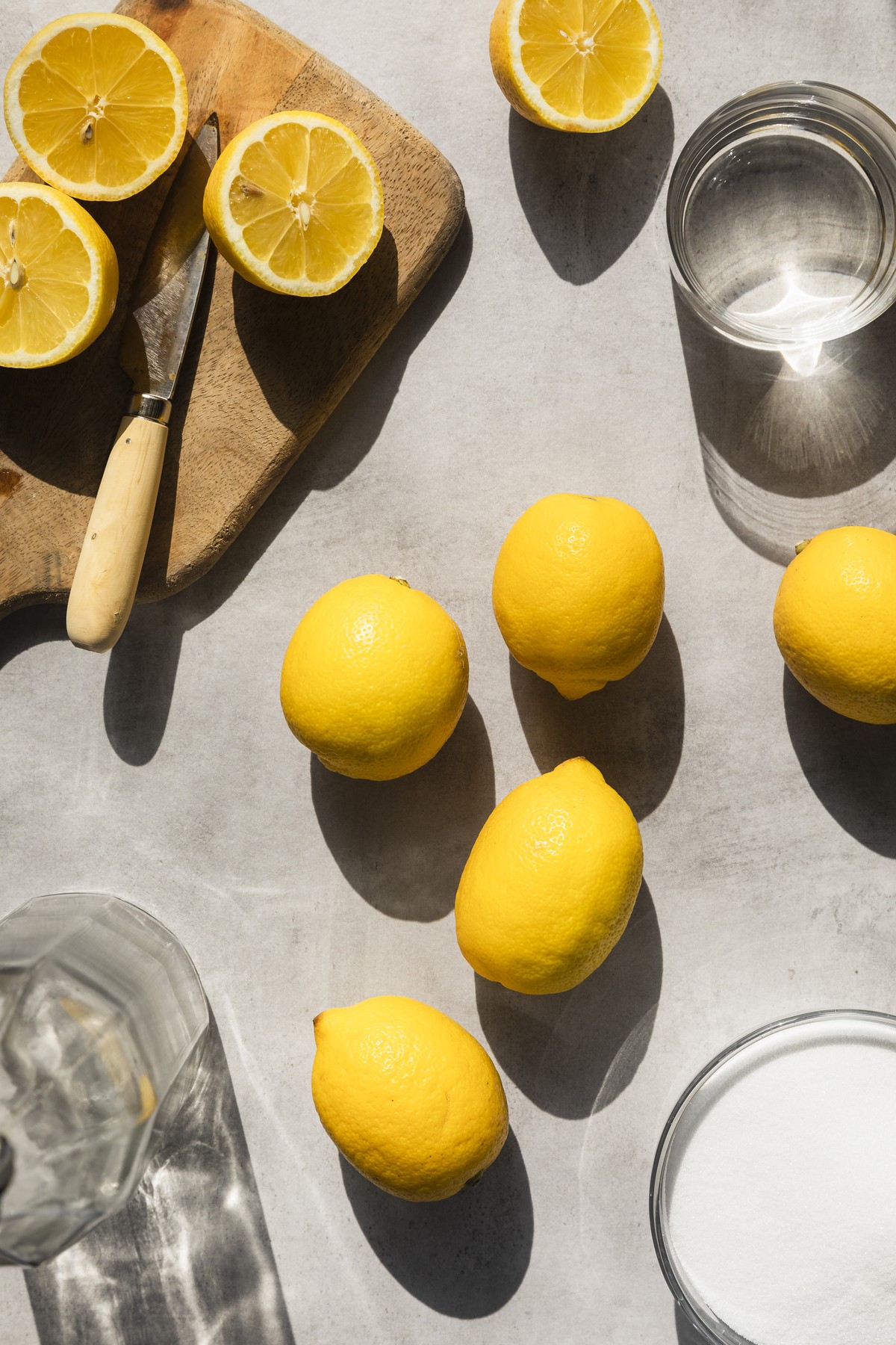 Lemons in hard light, with sugar, water and sliced lemons surrounding.,Image: 795593380, License: Royalty-free, Restrictions: , Model Release: no, Credit line: Jo Bryant / The Picture Pantry / Profimedia