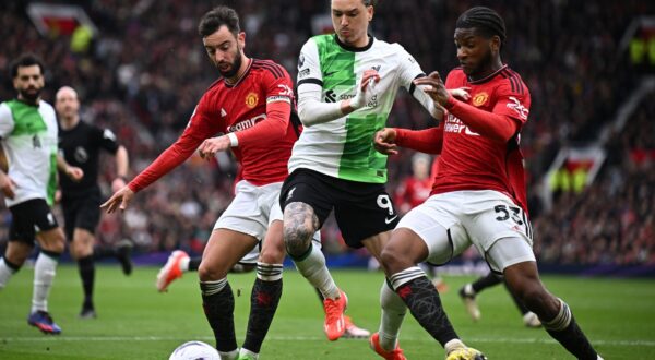 Liverpool's Uruguayan striker #09 Darwin Nunez (C) vies with Manchester United's Portuguese midfielder #08 Bruno Fernandes (L) and Manchester United's Conoglese-born French defender #53 Willy Kambwala (R) during the English Premier League football match between Manchester United and Liverpool at Old Trafford in Manchester, north west England, on April 7, 2024.,Image: 863130360, License: Rights-managed, Restrictions: RESTRICTED TO EDITORIAL USE. No use with unauthorized audio, video, data, fixture lists, club/league logos or 'live' services. Online in-match use limited to 120 images. An additional 40 images may be used in extra time. No video emulation. Social media in-match use limited to 120 images. An additional 40 images may be used in extra time. No use in betting publications, games or single club/league/player publications., Model Release: no, Credit line: Paul ELLIS / AFP / Profimedia