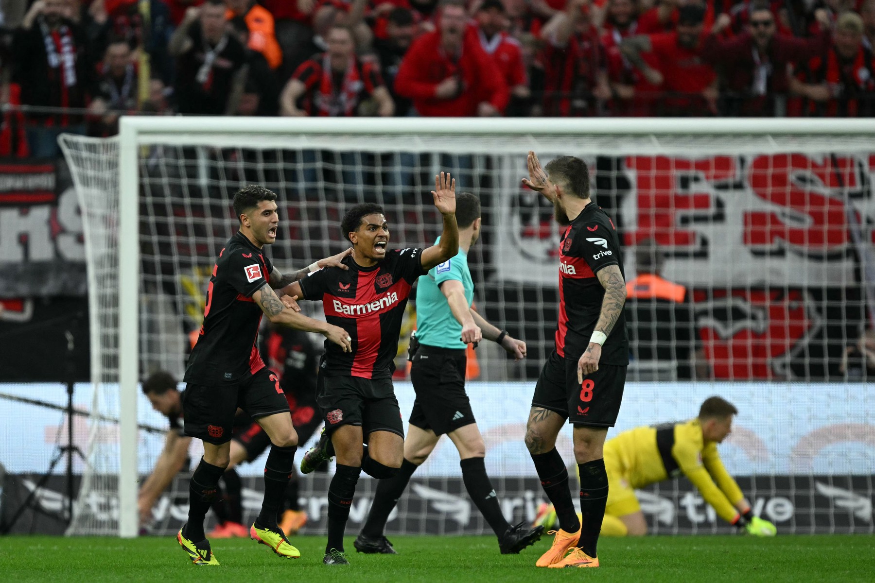 Bayer Leverkusen's French forward #21 Amine Adli (C) celebrates scoring the 1-2 goal with his team-mates during the German first division Bundesliga football match Bayer 04 Leverkusen v VfL Stuttgart in Leverkusen, western Germany, on April 27, 2024.,Image: 868427066, License: Rights-managed, Restrictions: DFL REGULATIONS PROHIBIT ANY USE OF PHOTOGRAPHS AS IMAGE SEQUENCES AND/OR QUASI-VIDEO, Model Release: no, Credit line: INA FASSBENDER / AFP / Profimedia