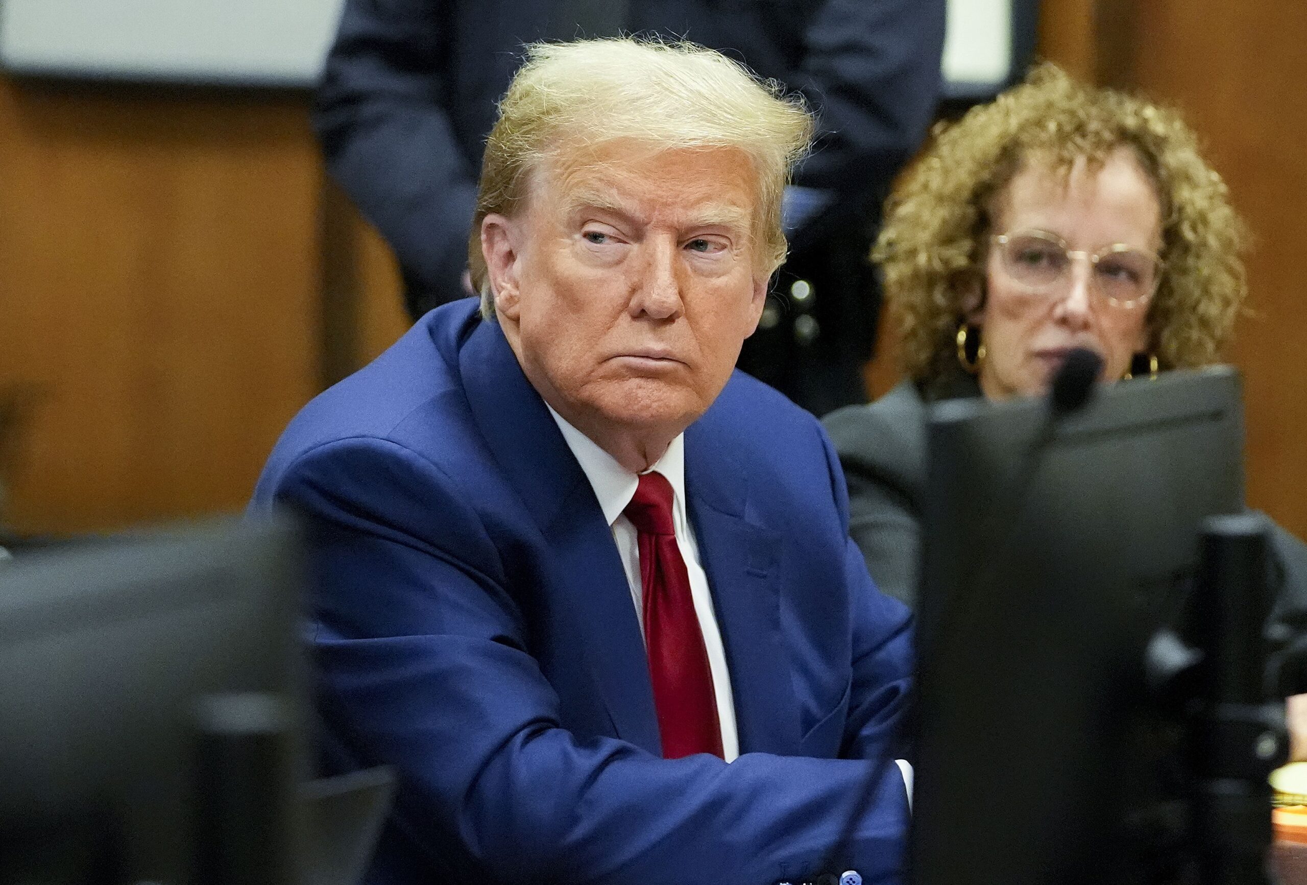 epa11242882 Former US President Donald Trump (L) with his lawyer Susan Necheles (R) awaits the start of a pre-trial hearing with his defense team in Manhattan criminal court in New York City, New York, USA, 25 March 2024. A judge will weigh when the former president will go on trial. Trump is facing 34 felony counts of falsifying business records related to payments made to adult film star Stormy Daniels during his 2016 presidential campaign.  EPA/MARY ALTAFFER / POOL