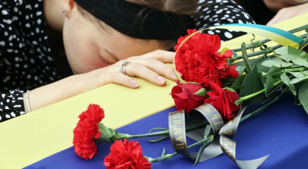 September 1, 2023, Poltava, Ukraine: A woman stays by a coffin during the funeral ceremony of pilots and technicians of two Mi-8 helicopters outside the Church of the Nativity of the Blessed Virgin Mary, Poltava, central Ukraine. Two Mi-8 helicopters crashed near Novoiavlenka village, Donetsk Region, while on a combat mission on Tuesday, August 29. Four pilots and two technicians of the 18th Igor Sikorsky Separate Army Aviation Brigade died in the accident.,Image: 802056304, License: Rights-managed, Restrictions: , Model Release: no, Credit line: Vyacheslav Madiyevskyy / Zuma Press / Profimedia