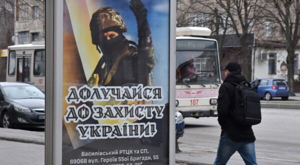 A man walks past the recruitment poster for the Ukrainian armed forces in the center of Zaporizhzhia. When Russia launched its full-scale invasion in 2022, many Ukrainians volunteered to defend their country. But that pool has been exhausted and a large proportion of the men of fighting age are unwilling to be deployed to the front. Only men aged 27 or older have been recruited, with those serving on the battlefield being on average in their 40s. A new mobilisation law â€” due to be put to a parliamentary vote on March 31 â€” seeks to update the countryâ€™s legal framework ahead of a probable recruitment wave this year in which up to 500,000 people could be drafted. - Andriy Andriyenko / SOPA Images//SOPAIMAGES_08480043/Credit:SOPA Images/SIPA/2403210919,Image: 858451341, License: Rights-managed, Restrictions: , Model Release: no, Credit line: SOPA Images / Sipa Press / Profimedia