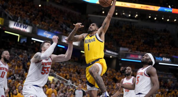 Indiana Pacers forward Obi Toppin (1) drives to the basket over New York Knicks center Isaiah Hartenstein (55) and forward Precious Achiuwa (5) during the second half of Game 6 in an NBA basketball second-round playoff series, Friday, May 17, 2024, in Indianapolis. (AP Photo/Michael Conroy)