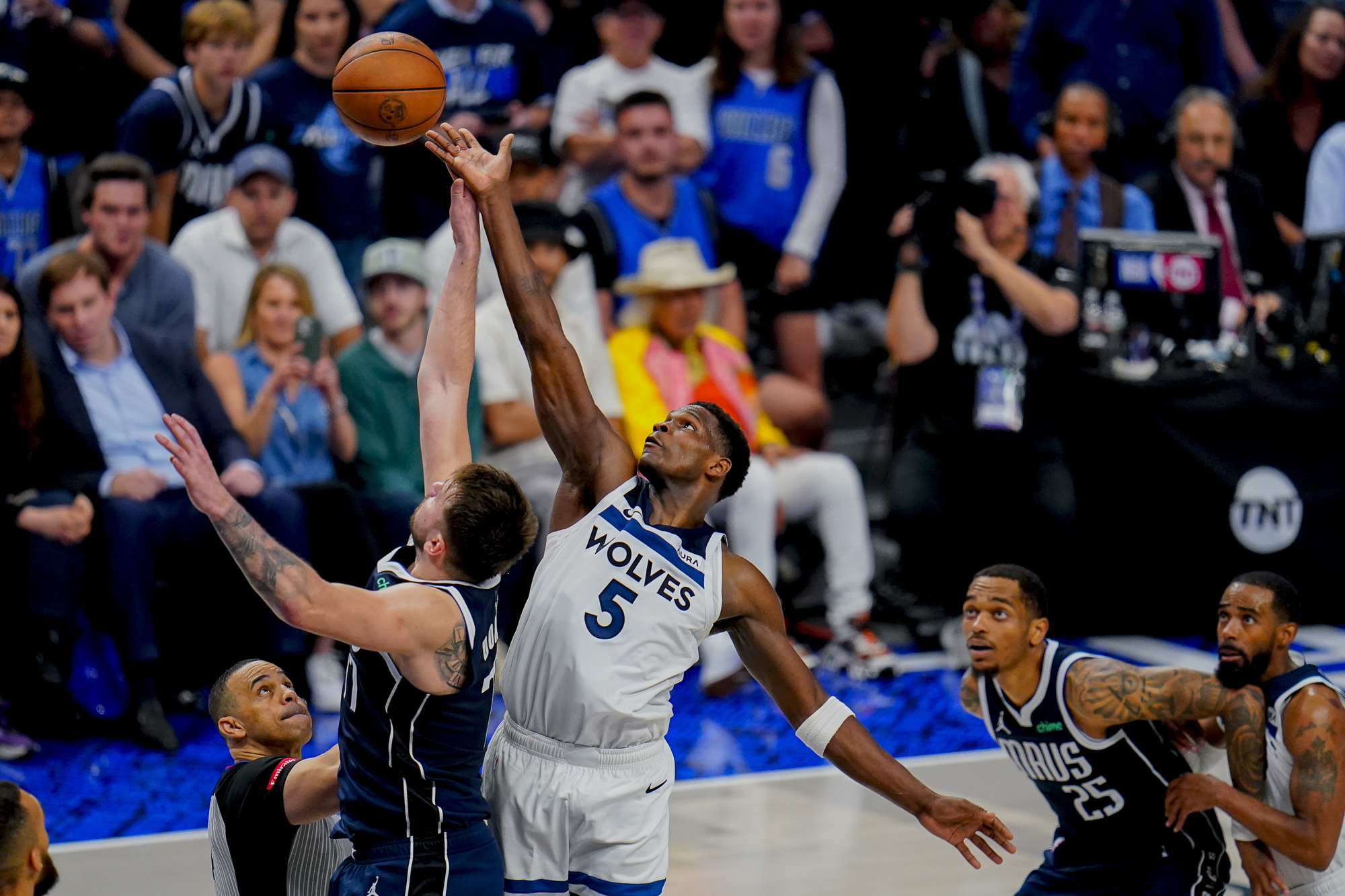 Dallas Mavericks guard Luka Doncic, left, compete for a jump ball against Minnesota Timberwolves guard Anthony Edwards (5) during the second half in Game 3 of the NBA basketball Western Conference finals, Sunday, May 26, 2024, in Dallas. (AP Photo/Gareth Patterson)