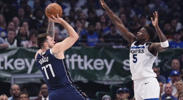 Dallas Mavericks guard Luka Doncic (77) shoots against Minnesota Timberwolves guard Anthony Edwards (5) during the first half in Game 4 of the NBA basketball Western Conference finals, Tuesday, May 28, 2024, in Dallas. (AP Photo/Julio Cortez)