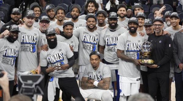 The Dallas Mavericks celebrate as they pose for a team photograph after Game 5 of the Western Conference finals in the NBA basketball playoffs against the Minnesota Timberwolves, Thursday, May 30, 2024, in Minneapolis. The Mavericks won 124-103, taking the series 4-1 and moving on to the NBA Finals. (AP Photo/Abbie Parr)