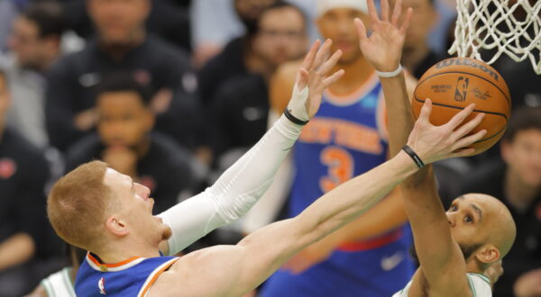 epa11274095 New York Knicks guard Donte DiVincenzo (L) shoots around Boston Celtics guard Derrick White (R) during the first half of the NBA game between the Boston Celtics and the New York Knicks in Boston, Massachusetts, USA, 11 April 2024.  EPA/CJ GUNTHER  SHUTTERSTOCK OUT