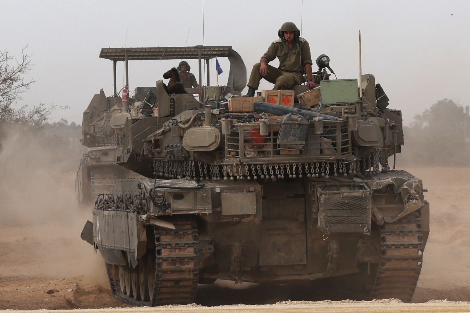 epa11300497 An Israeli tank at a gathering location on the southern Israeli border with the Gaza Strip near Rafah, 25 April 2024. More than 34,000 Palestinians and over 1,450 Israelis have been killed, according to the Palestinian Health Ministry and the Israel Defense Forces (IDF), since Hamas militants launched an attack against Israel from the Gaza Strip on 07 October 2023, and the Israeli operations in Gaza and the West Bank which followed it.  EPA/ATEF SAFADI