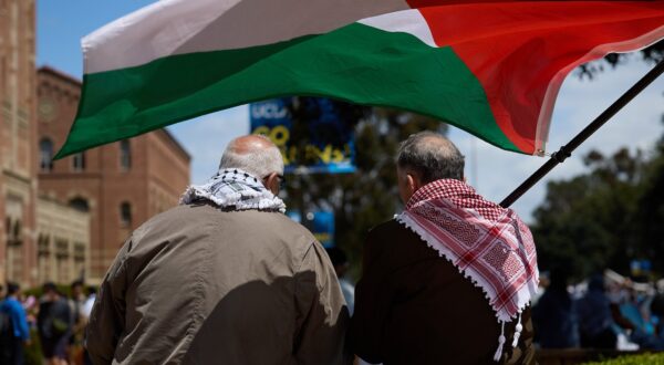 epa11301414 Two men wave the Palestinian flag as University of California Los Angeles (UCLA) students set up a Gaza solidarity encampment on campus to advocate for Palestine in Los Angeles, California, USA, 25 April 2024. More than 34,000 Palestinians and over 1,450 Israelis have been killed, according to the Palestinian Health Ministry and the Israel Defense Forces (IDF), since Hamas militants launched an attack against Israel from the Gaza Strip on 07 October 2023, and the Israeli operations in Gaza and the West Bank which followed it.  EPA/ALLISON DINNER