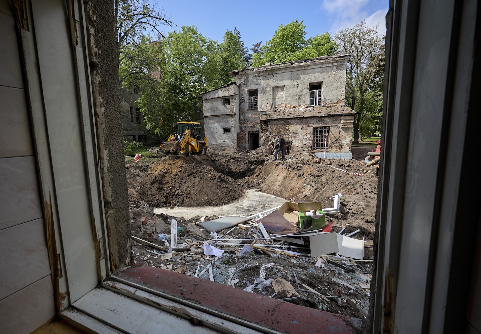 epa11304560 Communal workers operate at the site of a rocket attack on a regional psychiatric hospital in Kharkiv, northeastern Ukraine, 27 April 2024. According to the Regional Prosecutor's Office Russia hit the city with two missiles of the S-300 type from the territory of the Belgorod region. In total, Russia used 34 air, ground, and sea-based missiles for the night time shelling of Ukraine as Air Force Command of UA Armed Forces reported. 21 were shot down by Ukrainian troops. As a result of the attack, the enterprise equipment of the four thermal power plants was seriously damaged according to the DTEK Group energy holding report.  EPA/SERGEY KOZLOV