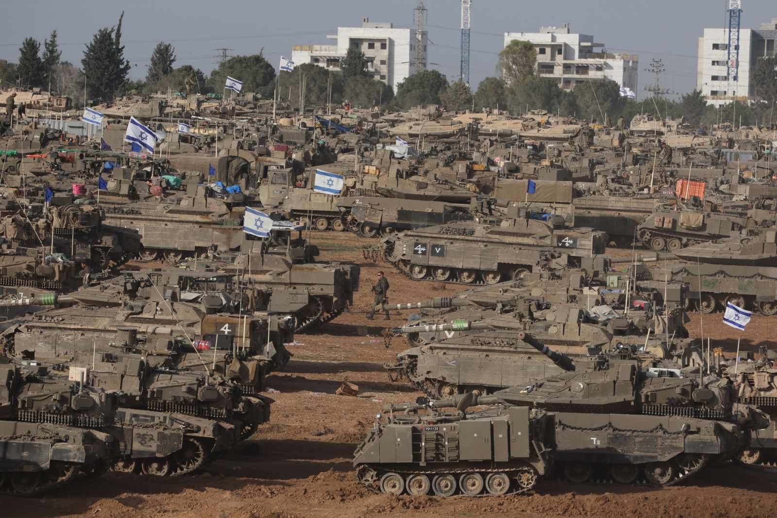 epa11329410 Israeli military vehicles gathered near the border fence with the Gaza Strip, at an undisclosed location in southern Israel, 09 May 2024. On 07 May, Israel said that its troops began an operation targeting Hamas militants and infrastructure within specific areas of eastern Rafah, taking operational control of the Gazan side of the Rafah crossing. The United States on 08 May confirmed the decision to pause a shipment of 'high payload munitions' to Israel. More than 34,900 Palestinians and over 1,455 Israelis have been killed, according to the Palestinian Health Ministry and the Israel Defense Forces (IDF), since Hamas militants launched an attack against Israel from the Gaza Strip on 07 October 2023, and the Israeli operations in Gaza and the West Bank which followed it.  EPA/ABIR SULTAN