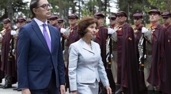 epa11335094 Outgoing President of North Macedonia Stevo Pendarovski (L) and the newly elected President Gordana Siljanovska Davkova (R) inspect the guard of honor during the handover ceremony at the President residence in Skopje in Skopje, North Macedonia, 12 May 2024.  EPA/GEORGI LICOVSKI