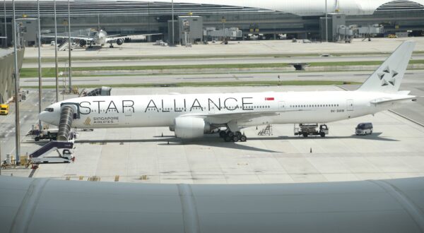 epa11359841 A photo taken through window glass of an aircraft observation deck shows a Singapore Airlines plane flight from London to Singapore parked one day after diverting an emergency landing at Suvarnabhumi International Airport in Samut Prakan province, Thailand, 22 May 2024. According to Singapore Airlines, at least one person died and more than 30 passengers were injured when a Singapore Airlines plane traveling from London to Singapore was diverted to Bangkok in an emergency due to severe turbulence.  EPA/RUNGROJ YONGRIT