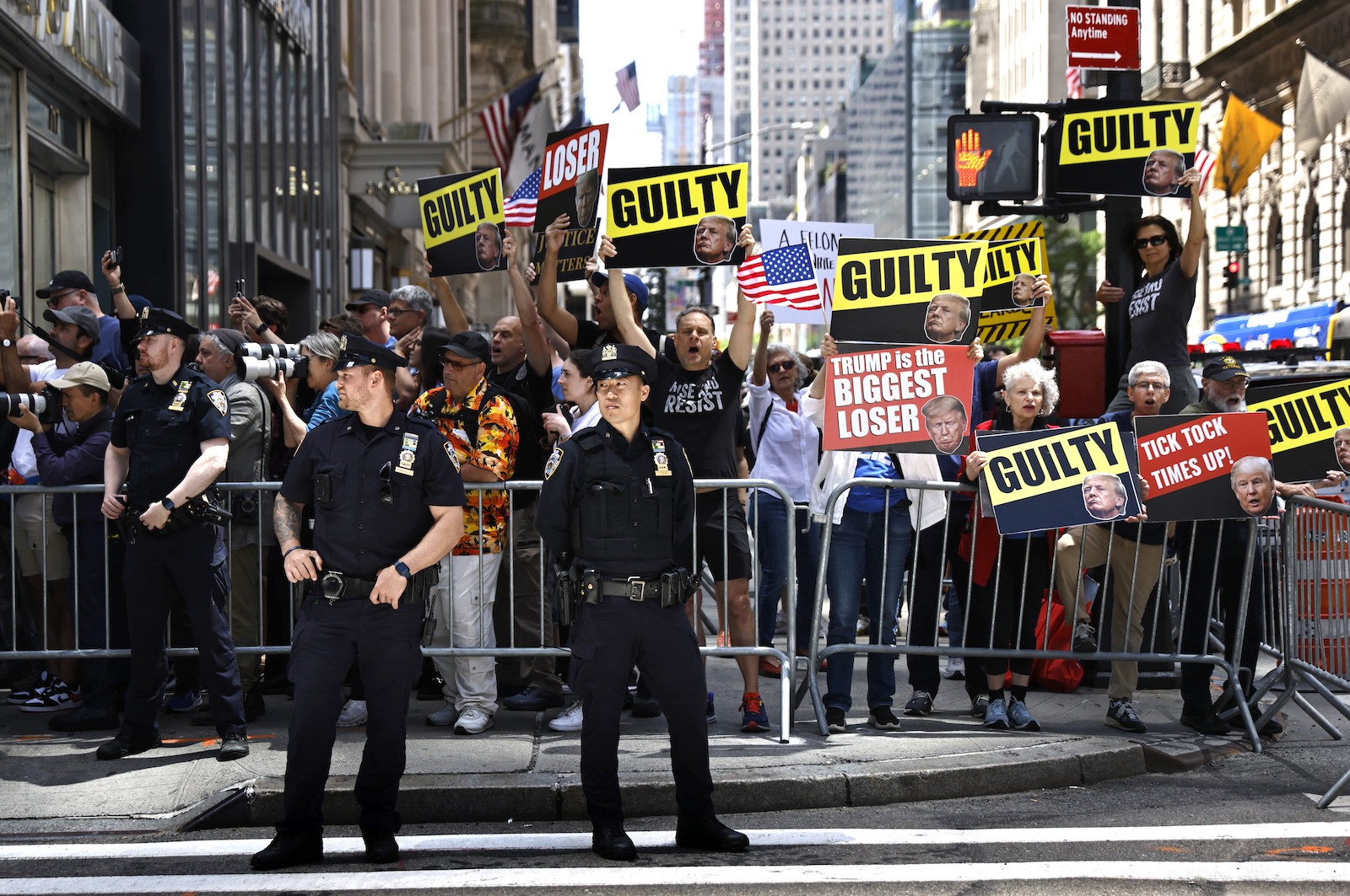 epa11382510 Protesters hold up signs outside of Trump Tower after former US President Donald Trump spoke at a press conference at Trump Tower the day after a jury found him guilty on all 34 counts in his hush money criminal trial in New York State Supreme Court in New York, New York, USA, 31 May 2024. Trump will be sentenced on 11 July 2024.  EPA/PETER FOLEY