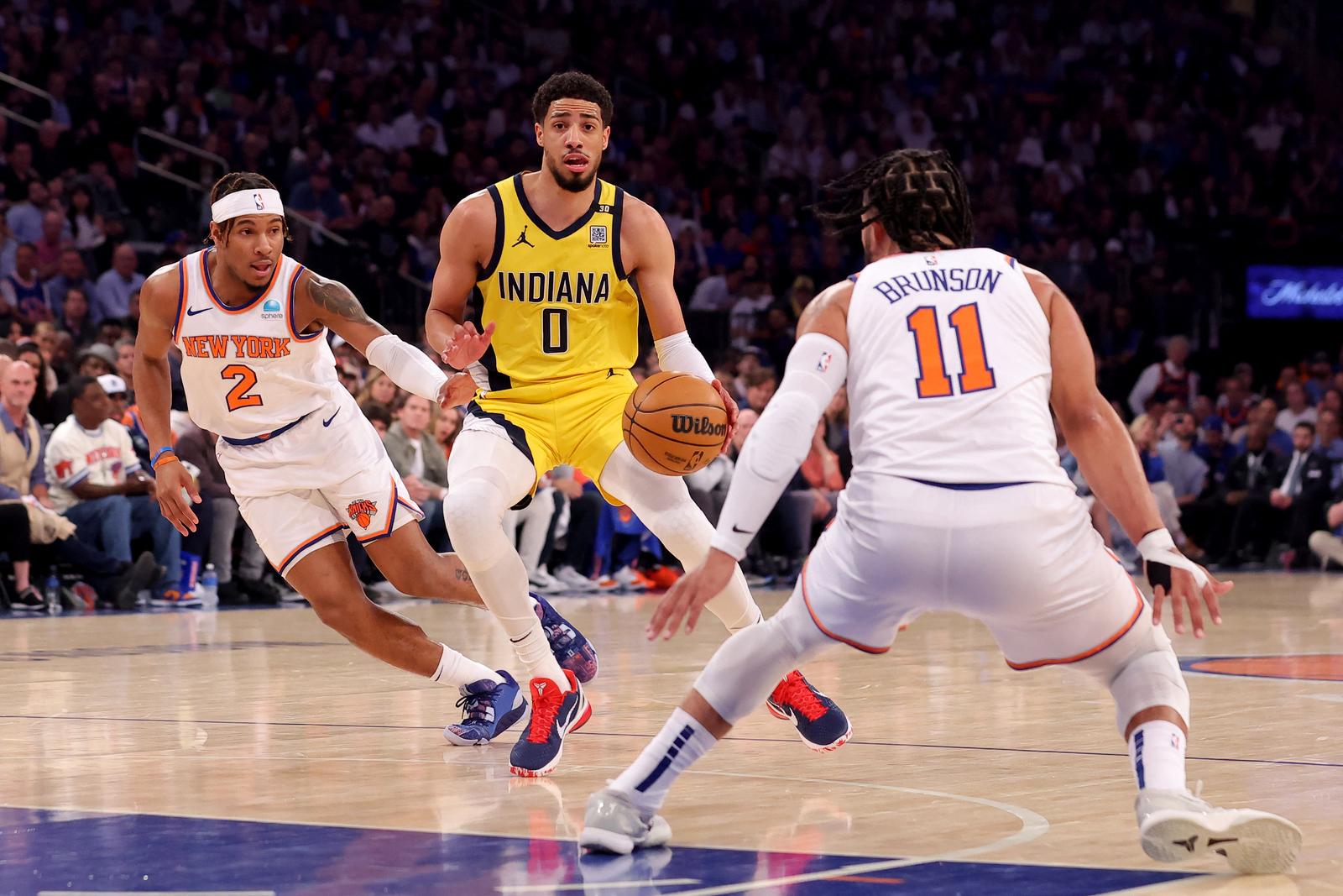 May 19, 2024; New York, New York, USA; Indiana Pacers guard Tyrese Haliburton (0) controls the ball against New York Knicks guards Miles McBride (2) and Jalen Brunson (11) during the first quarter of game seven of the second round of the 2024 NBA playoffs at Madison Square Garden. Mandatory Credit: Brad Penner-USA TODAY Sports Photo: Brad Penner/REUTERS