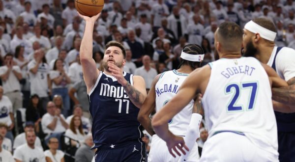 May 22, 2024; Minneapolis, Minnesota, USA; Dallas Mavericks guard Luka Doncic (77) shoots against Minnesota Timberwolves forward Jaden McDaniels (3) in the first quarter during game one of the western conference finals for the 2024 NBA playoffs at Target Center. Mandatory Credit: Jesse Johnson-USA TODAY Sports Photo: Jesse Johnson/REUTERS
