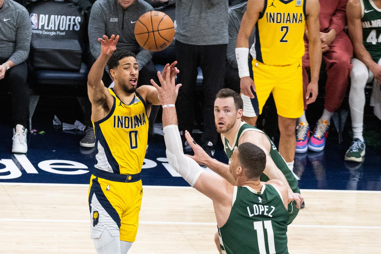 Apr 28, 2024; Indianapolis, Indiana, USA; Indiana Pacers guard Tyrese Haliburton (0) passes the ball while Milwaukee Bucks center Brook Lopez (11) defends during game four of the first round for the 2024 NBA playoffs at Gainbridge Fieldhouse. Mandatory Credit: Trevor Ruszkowski-USA TODAY Sports Photo: Trevor Ruszkowski/REUTERS
